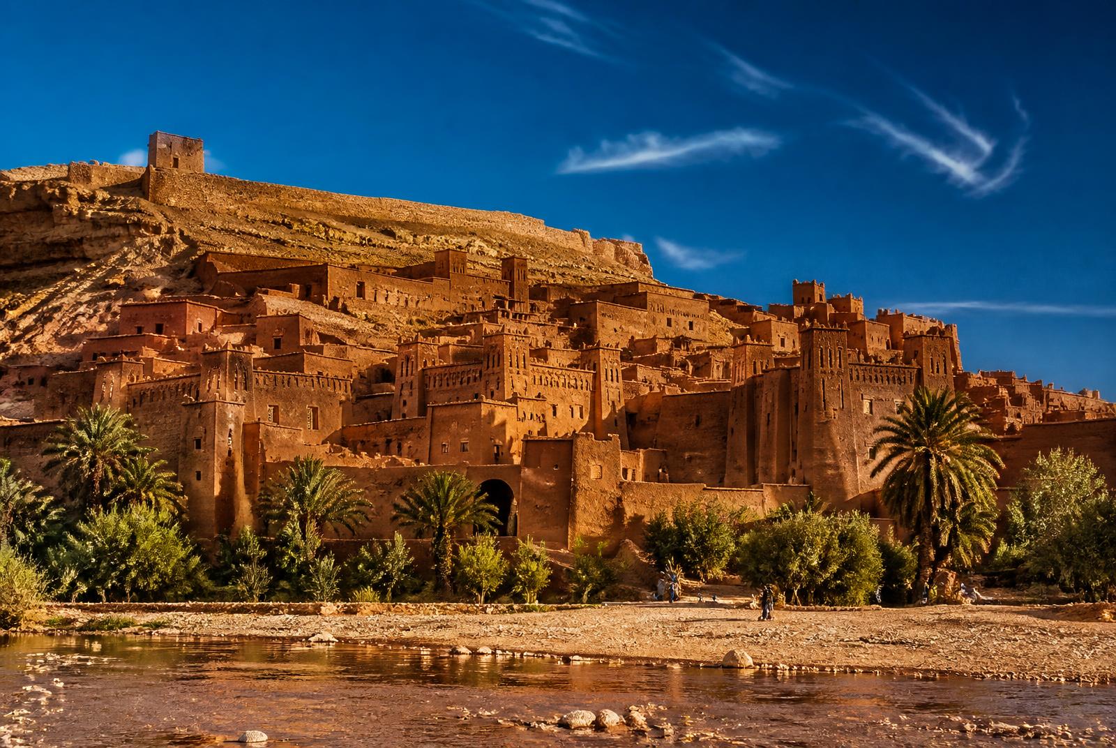 Earthen kasbah of Ait Benhaddou in southern Morocco glowing ochre in late afternoon light
